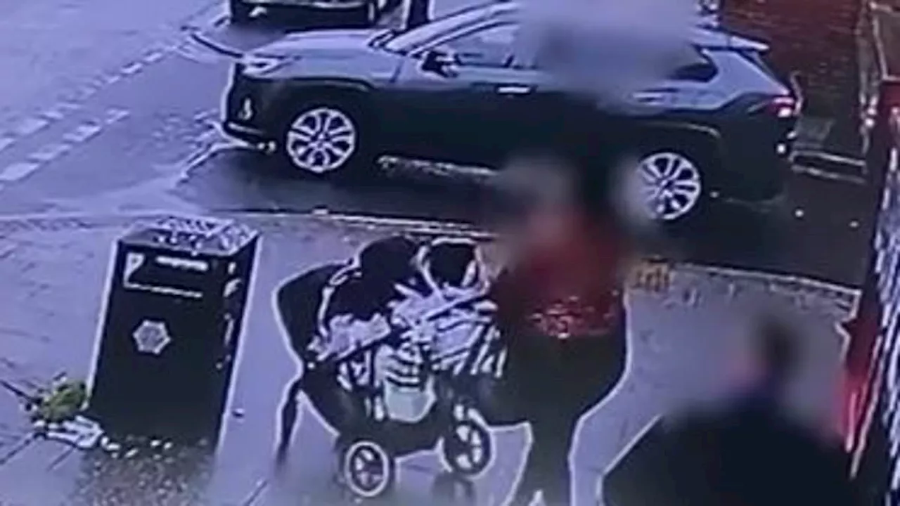 Shocking moment Jaguar zooms past mother pushing a pram along a pavement in Manchester before it...