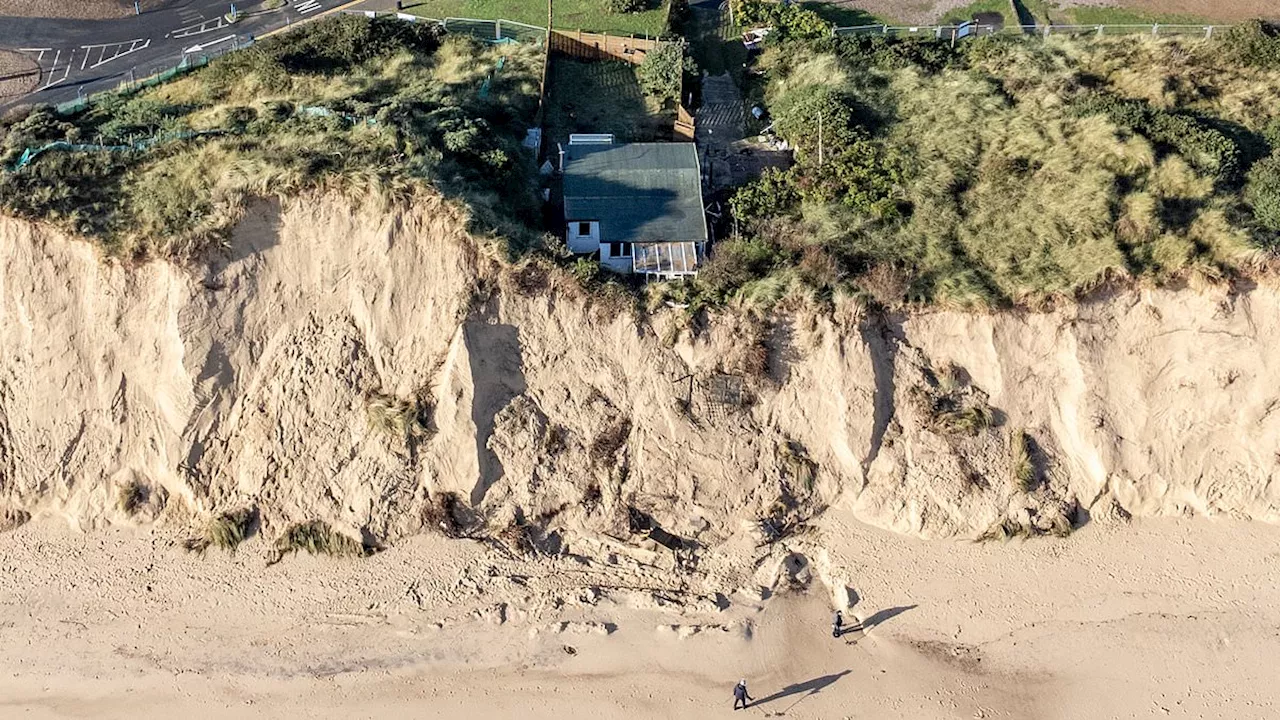 Shock images show house perilously close to toppling over cliff as residents of Norfolk village say...