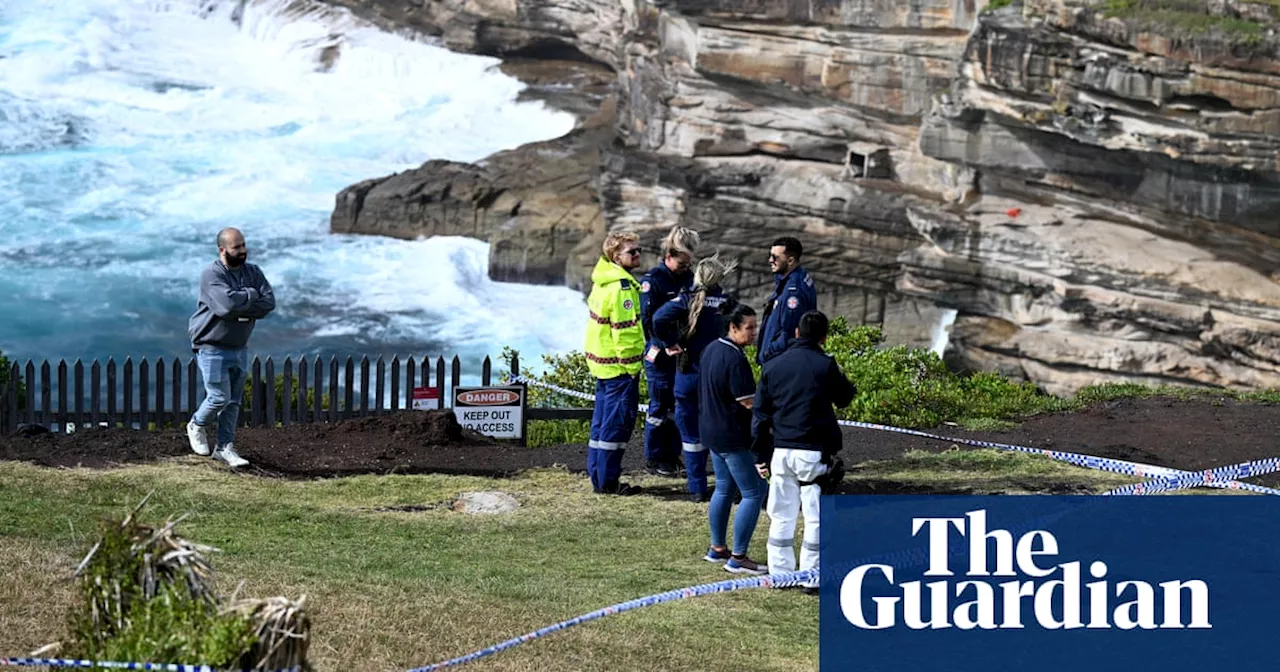 Body found in water as police search for man wanted over death of Sydney school coach