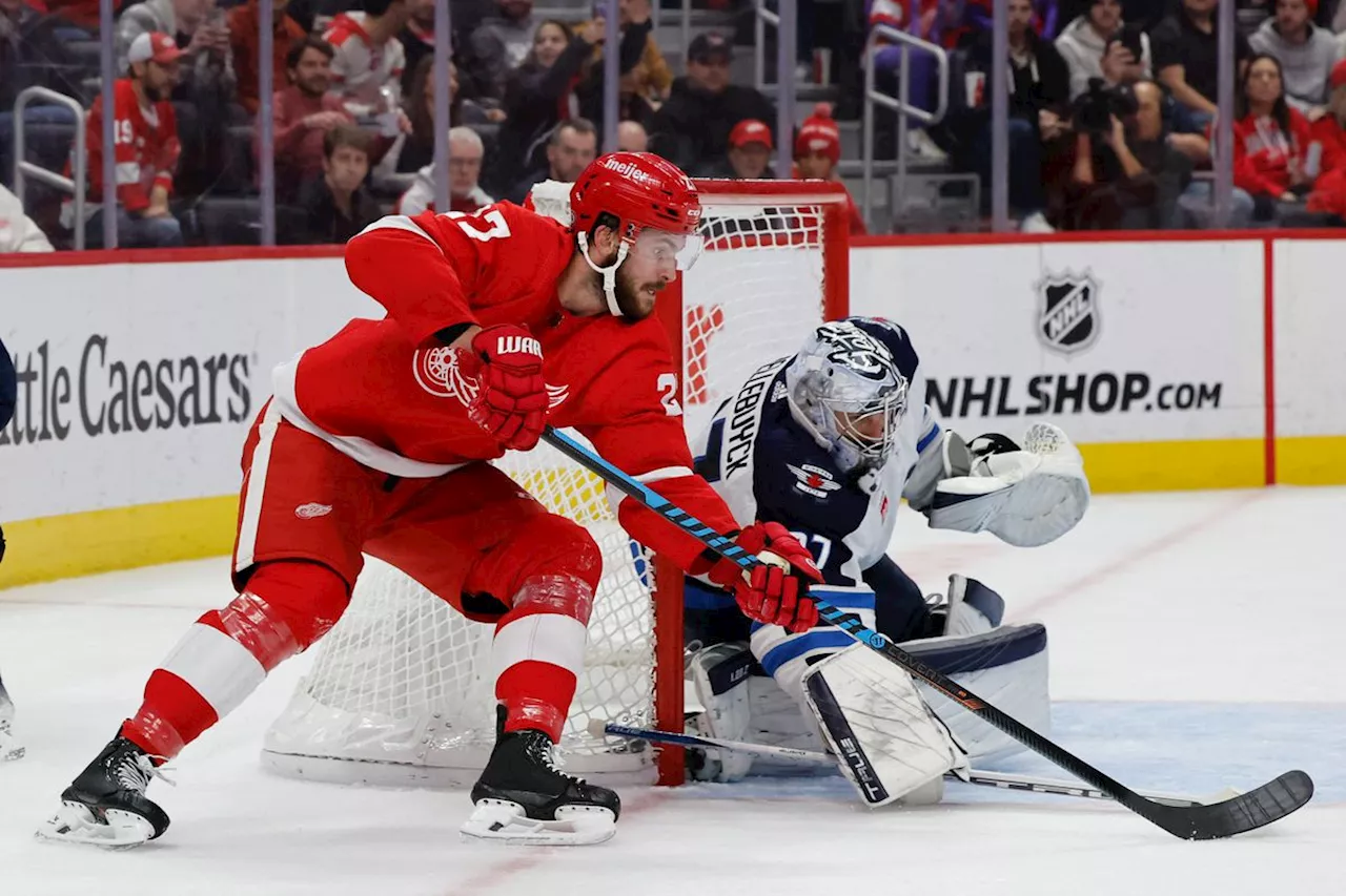 Hellebuyck makes 35 saves, leading the Jets to a 4-1 win over the Red Wings