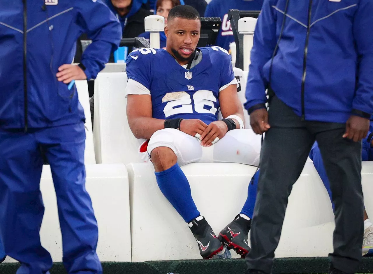 Saquon Barkley’s dad wears Jets gear as they leave stadium together after brutal Giants loss