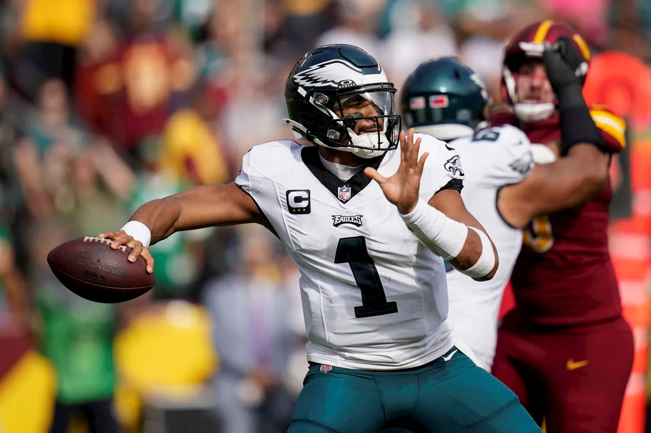 Jalen Hurts throws for 4 TDs on injured knee to help the Eagles beat the Commanders