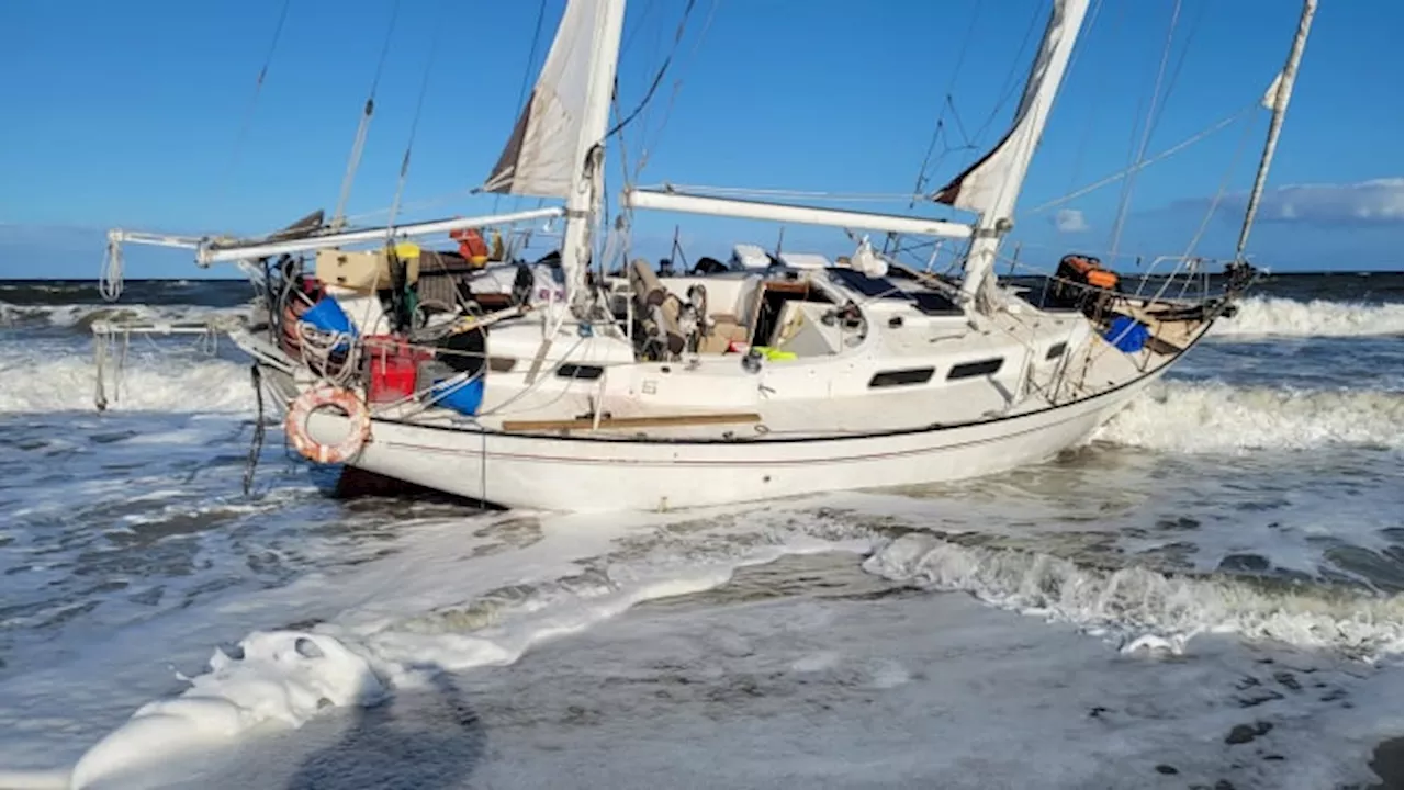 Rare washed ashore boat at Jacksonville Beach draws attention of many sightseers