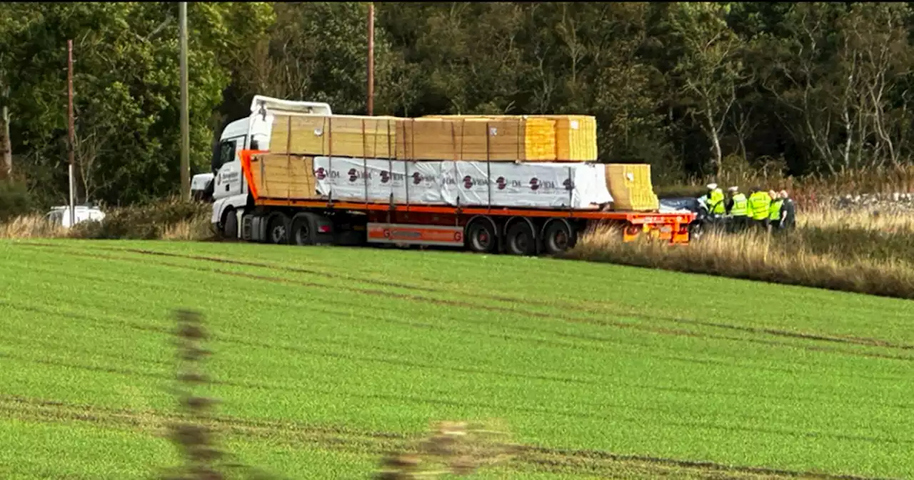 Lorry stuck in field after three-vehicle smash as emergency crews lock down A92