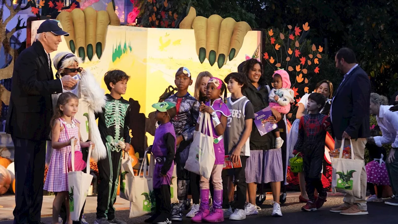 Biden and Jill Biden hand out books and candy while hosting thousands for rainy trick or treating