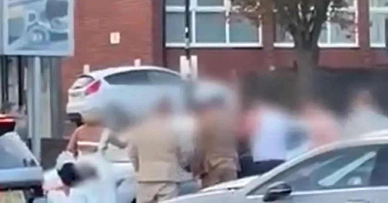 Moment bride wades into fight after brawl breaks out in hotel car park