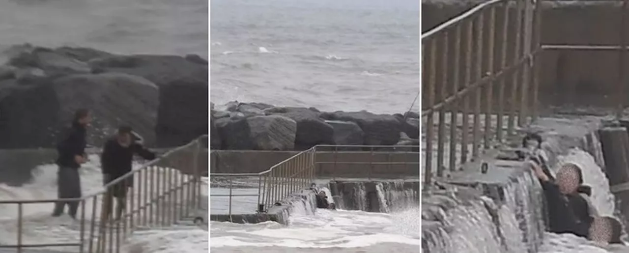 Casal de pescadores é varrido durante tempestade, mas se salva se agarrando 'pelas unhas' a píer