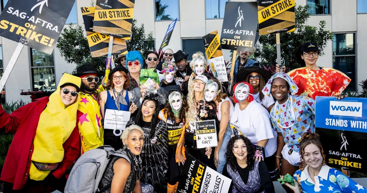 Photos: Actors scare up spooky costumes for Halloween on the picket lines