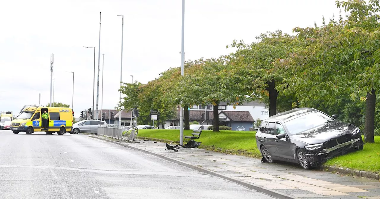 BMW driver in hospital after car crashes through barrier