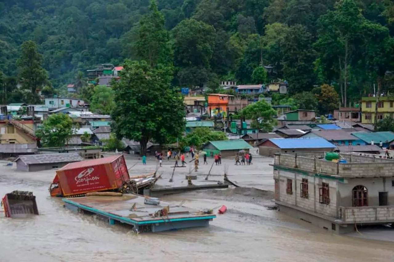 Flash floods kill at least 14 in India and leave more than 100 missing