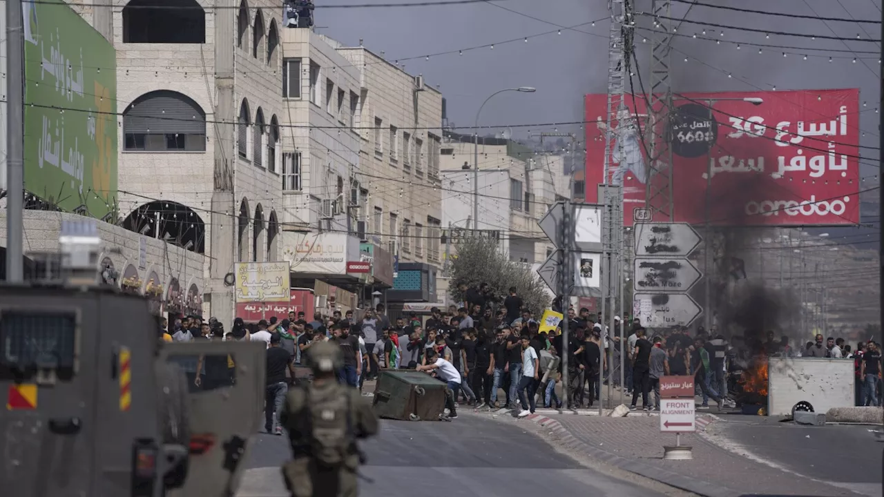 Palestinians march at youth's funeral procession after settler rampage in flashpoint West Bank town