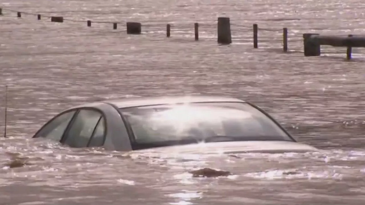 Two men saved after car gets stuck in Victoria floods