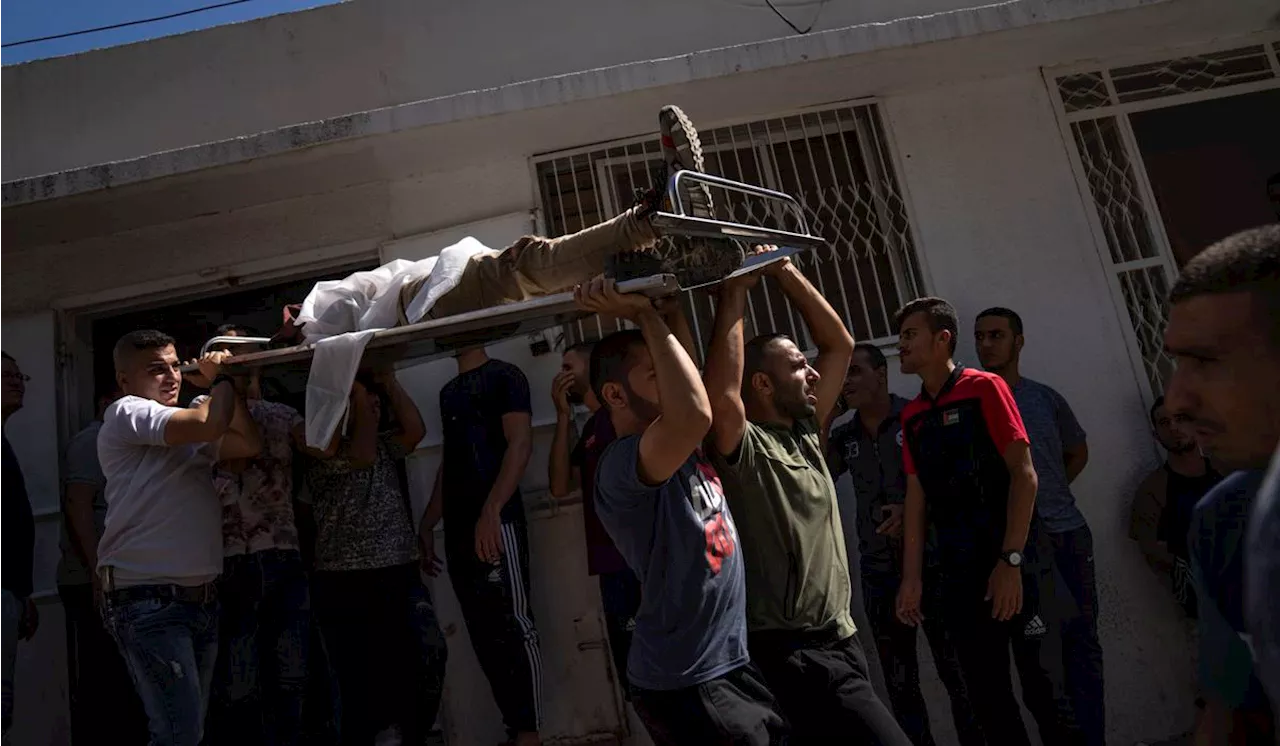 Palestinians say hundreds killed in Gaza in Israeli retaliation for a Hamas assault into Israel