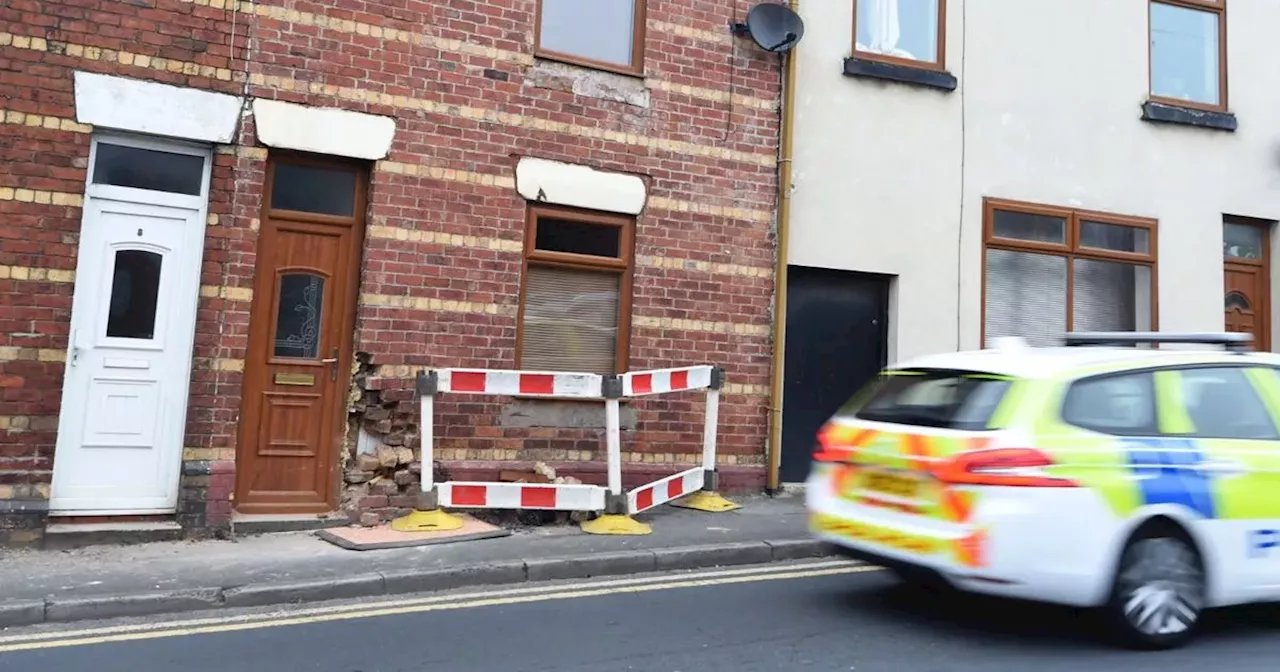 Bricks crumbling from home after car smashes into front wall