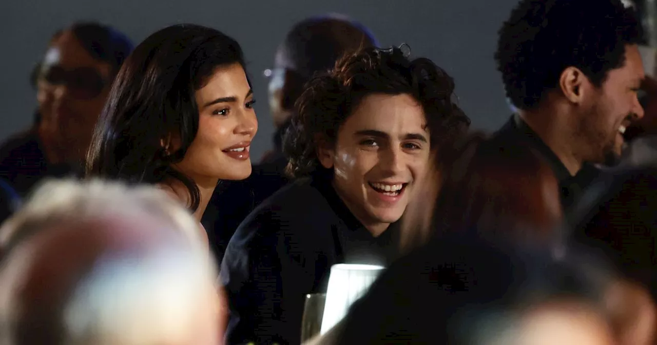 Kylie Jenner supported by Timothée Chalamet as pair don matching black outfits