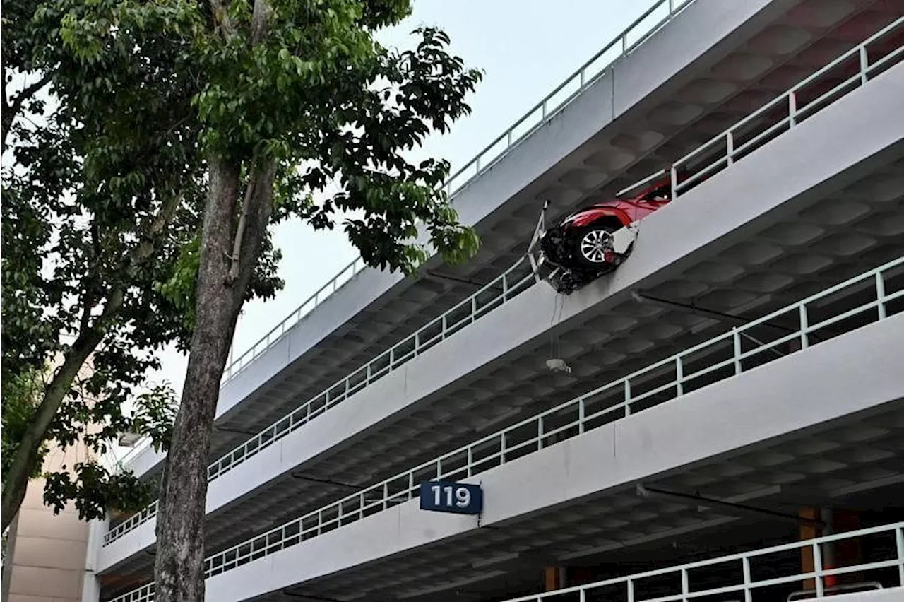 Car crashes through parapet wall at multi-storey carpark