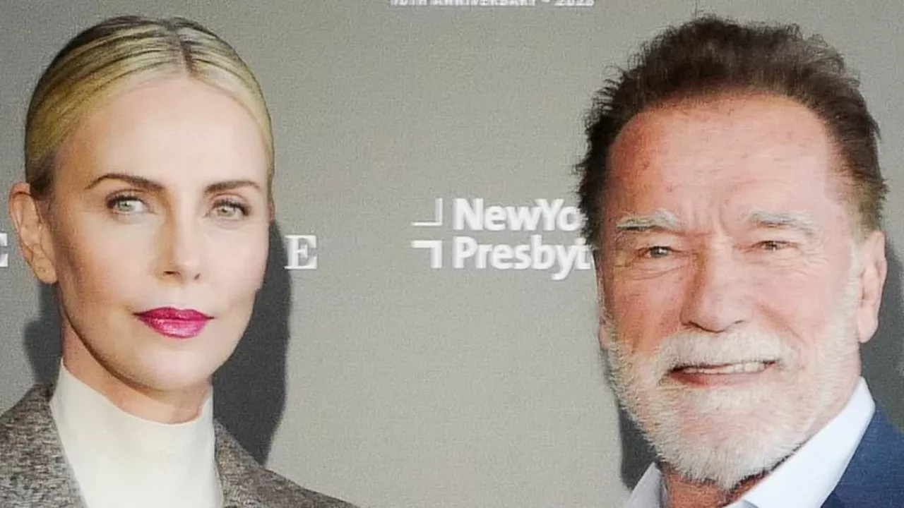 Charlize Theron looks business chic as she joins Arnold Schwarzenegger at this year's Town & Country...