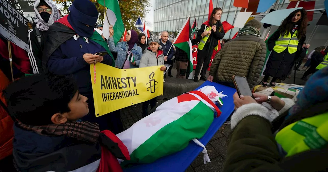 Protesters hold up body bags in protest over Gaza war outside BBC HQ in Glasgow