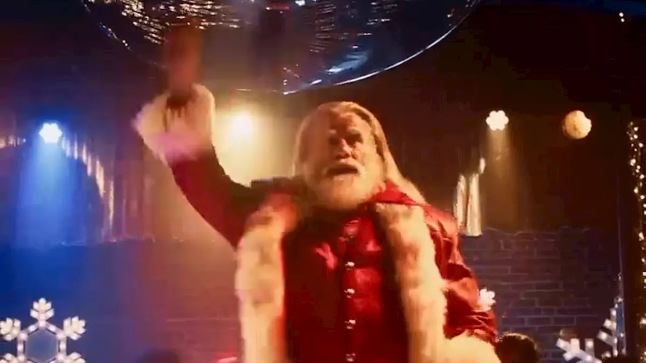 John Travolta, 69, transforms into Santa Claus and recreates THAT 1977 Saturday Night Fever dance...