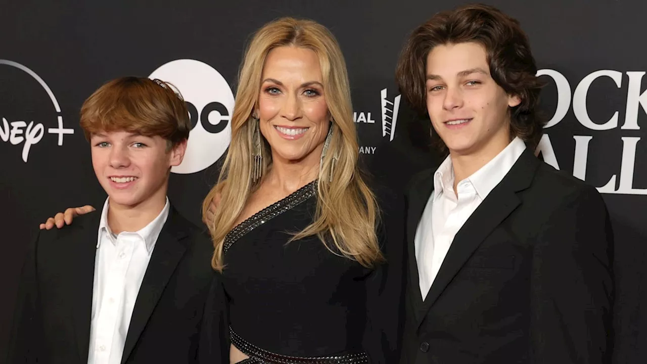 Sheryl Crow's young sons almost tower over her in rare public appearance for emotional evening