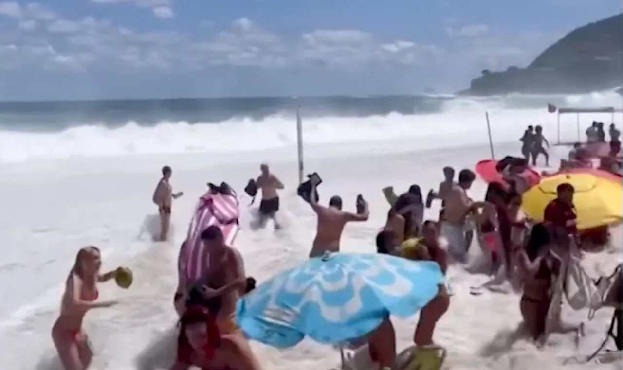 Sunbathers scramble for safety as massive wave hits in viral video