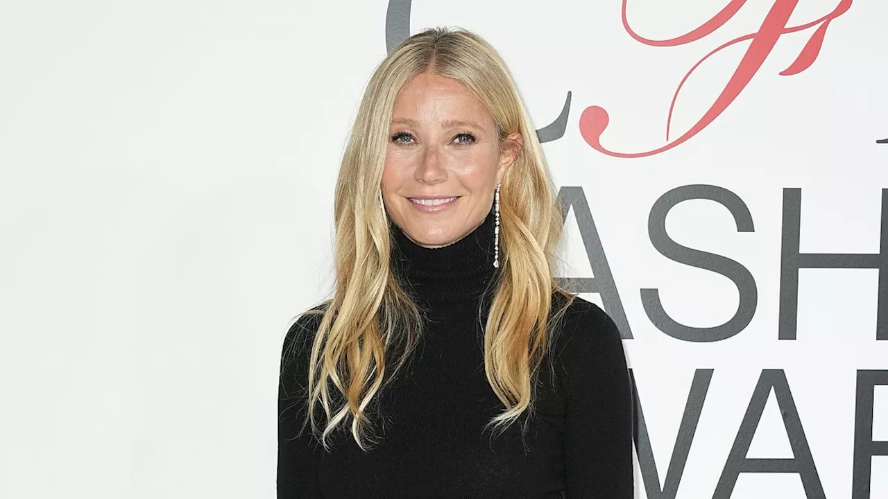 Gwyneth Paltrow dons a high-waisted black satin skirt as she accepts CFDA Fashion Award for...