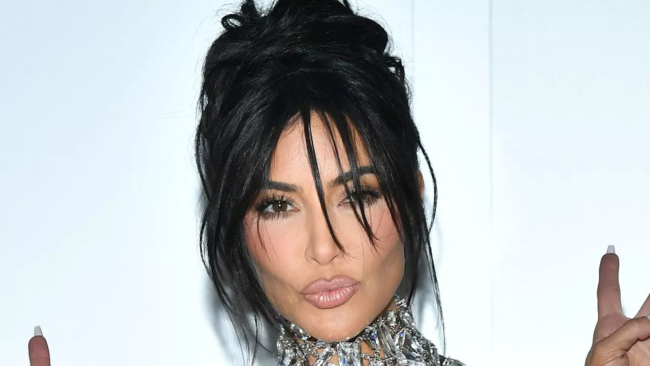 Kim Kardashian oozes glamour as she goes BRALESS under a dazzling crystal chain top and matching...