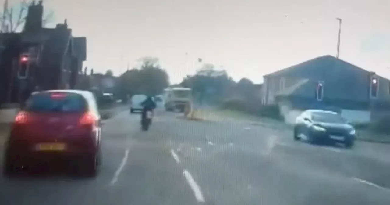 Moment young biker pulls 'ridiculous manoeuvre' right next to a police car