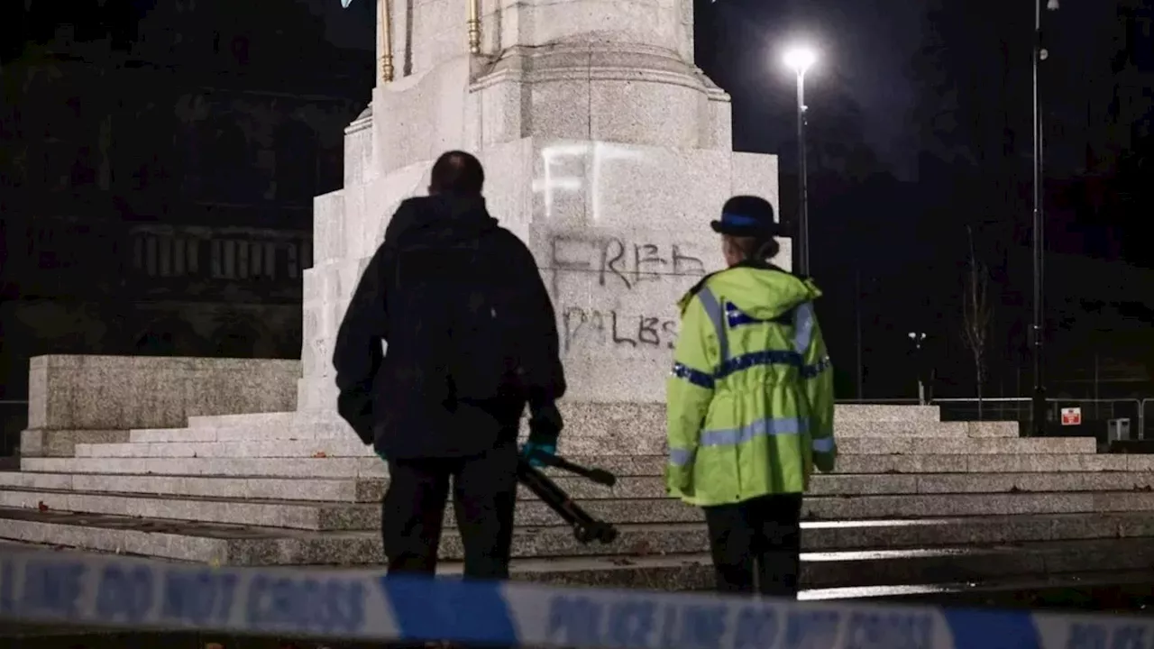 Fury as pro-Palestinian supporters deface war memorial as Manchester Police stand guard...