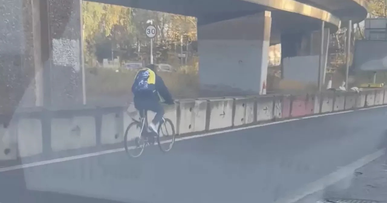 Glasgow cyclist seen attempting to merge onto M8 during morning rush hour
