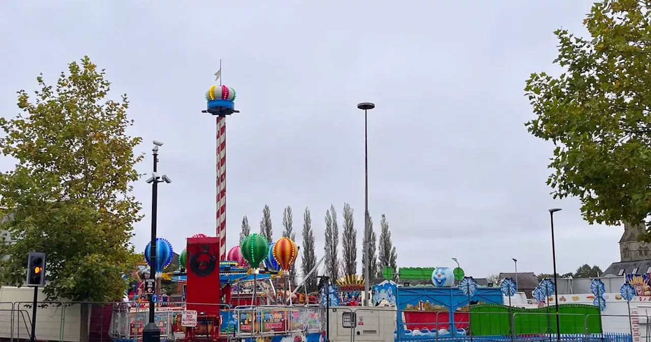 Man charged after car crashes into funfair and woman injured