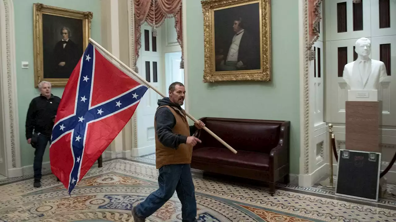 Man who stormed Capitol, threatened officer with Confederate flag gets 3 years in prison