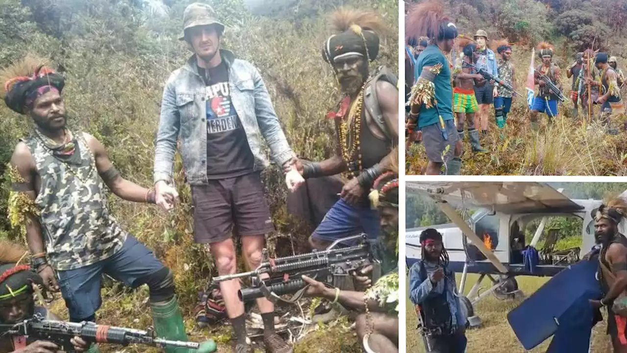 Alarming photos show downed Kiwi pilot captured by armed rebels in remote Pacific region, after they set fire to his plane