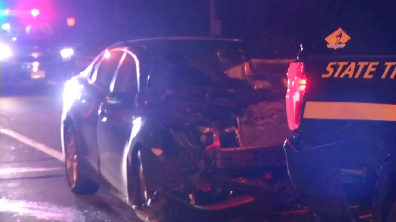 Delaware state trooper helping driver injured when car crashes into his cruiser