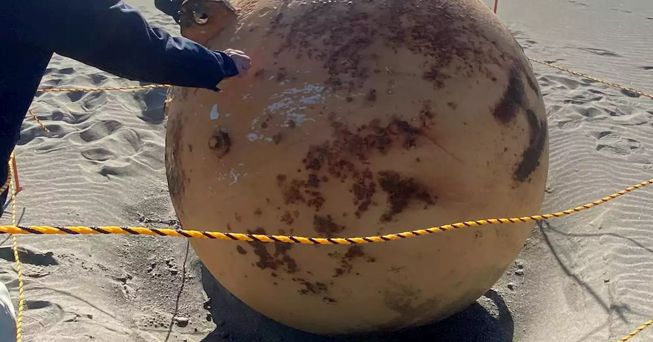 A mysterious, large metal ball was discovered on a beach in Japan, prompting investigation