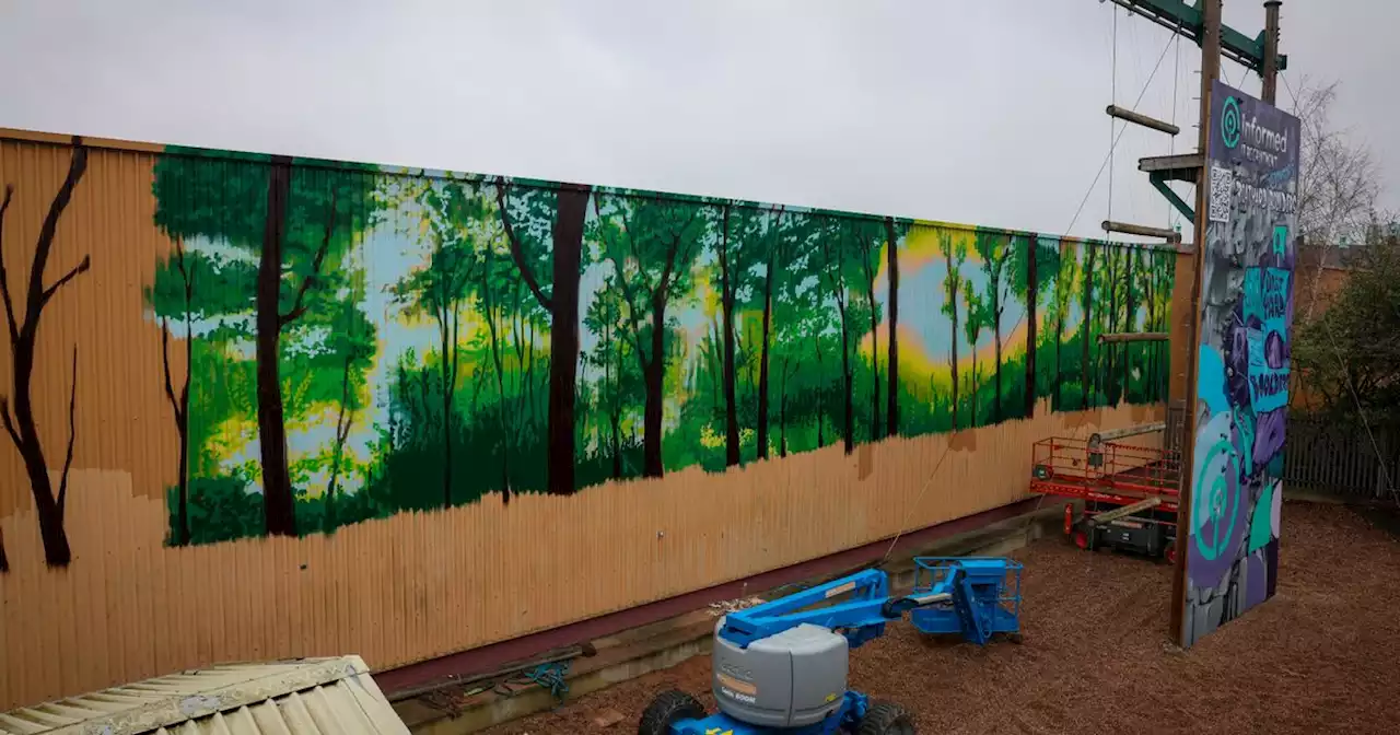 New mural featuring woodland landscape appears near bridge