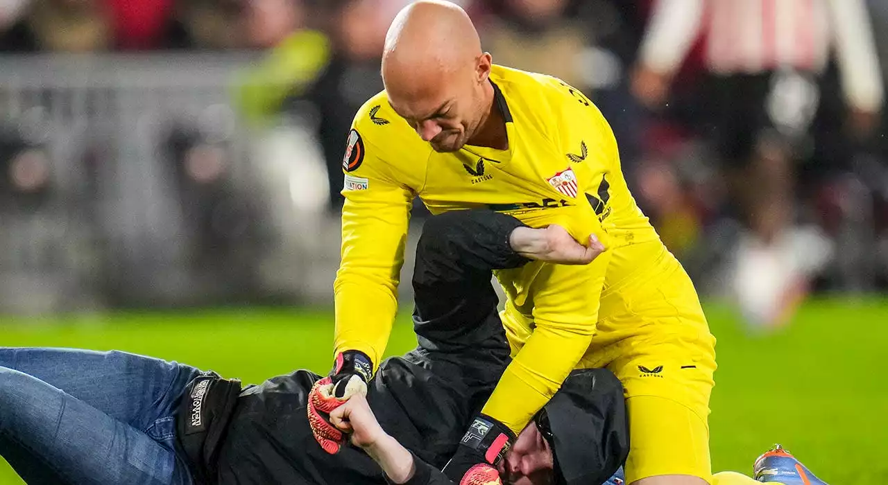 Fan punches soccer goalie during match; keeper wrestles him to ground before security steps in