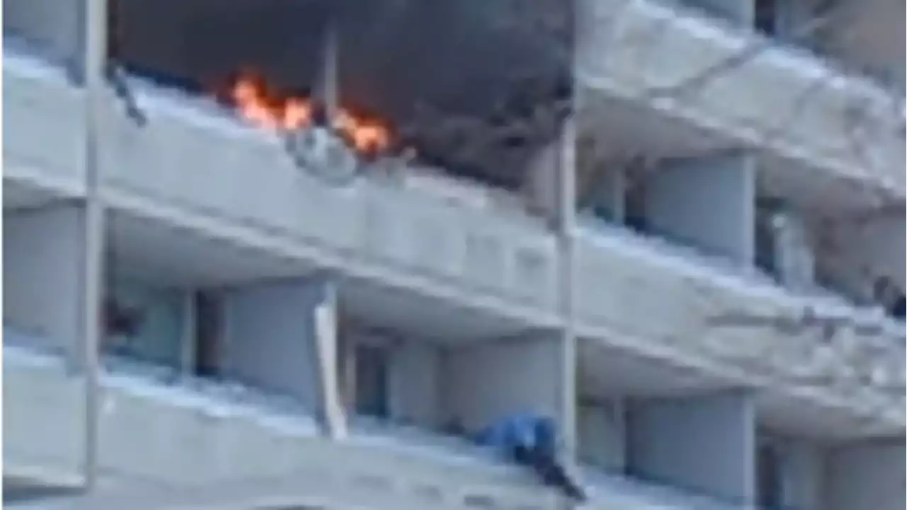 Video shows man dangling from balcony to escape Toronto high-rise fire