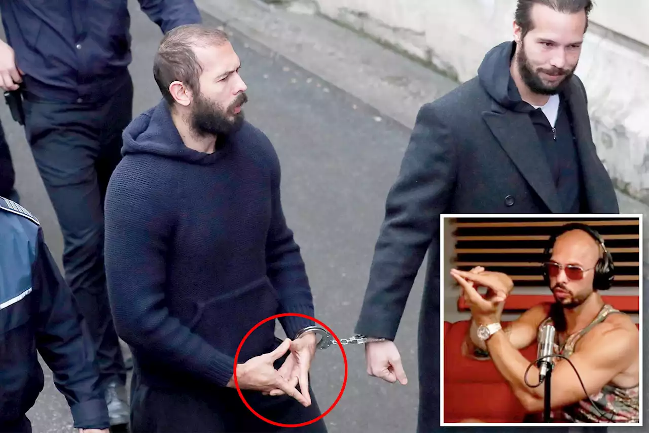 Andrew Tate flashes hand symbol as he’s led handcuffed into court