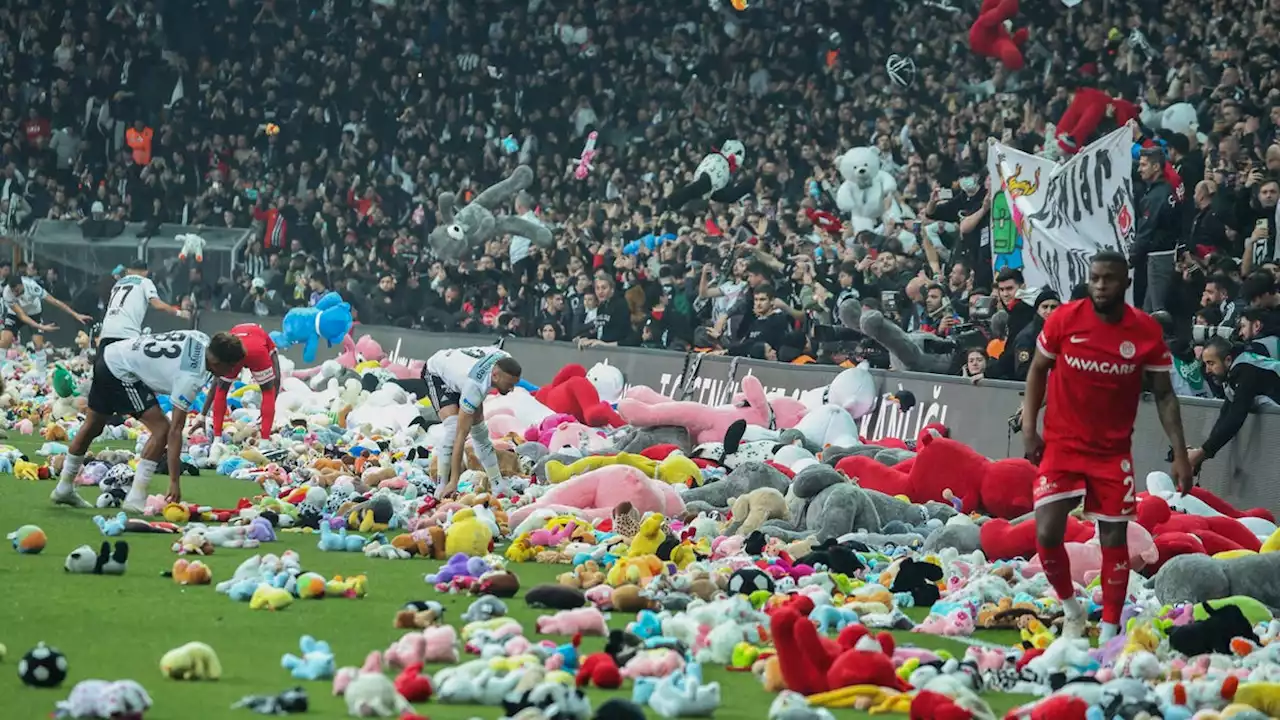 Fans of Turkish soccer club Beşiktaş J.K. toss stuffed toys onto pitch for children affected by earthquakes