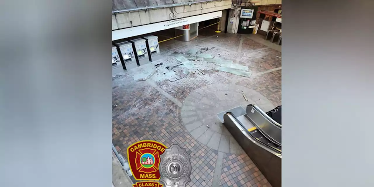 Car crashes through parking garage barrier, sending debris into train station below