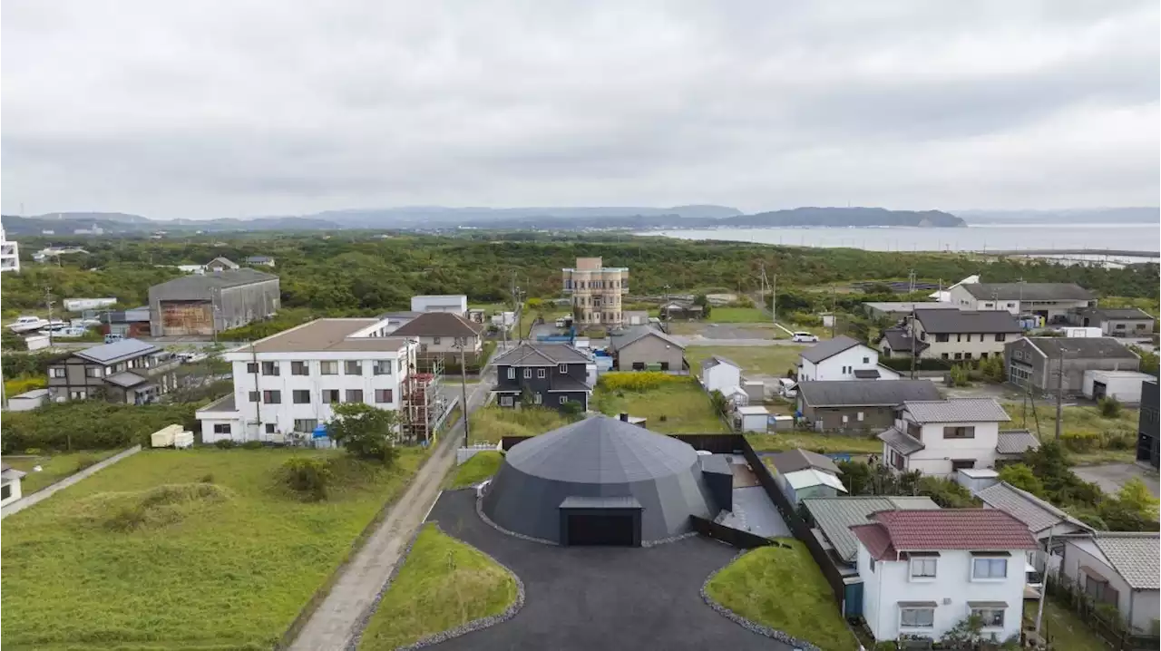 Circus tent structure inspires this Japanese holiday home for a car lover