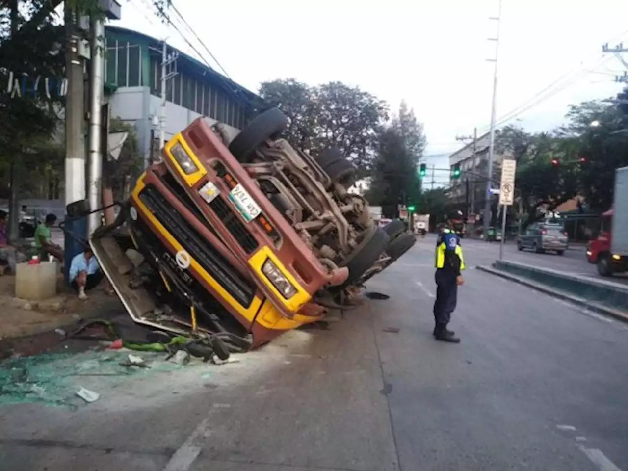 Truck loaded with bags of cement flips over, causes traffic jam in Manila