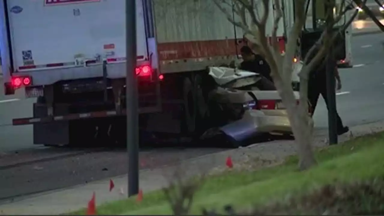 Man killed after crashing car into tractor-trailer, car wedged under truck