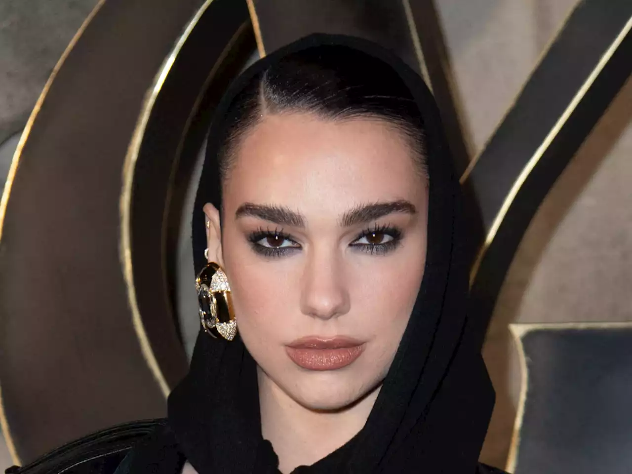 Dua Lupa : dans une combinaison à capuche noire à Paris elle paraît mystérieuse - Grazia