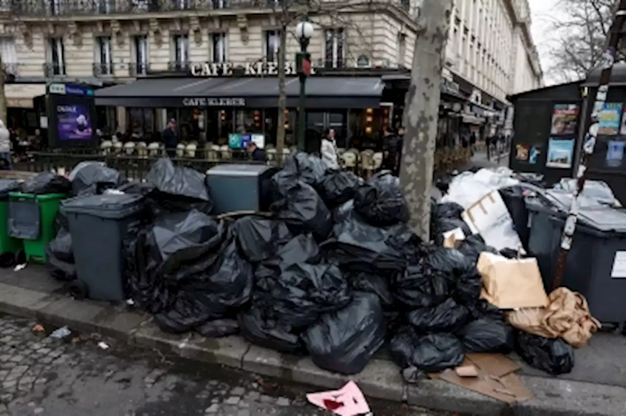 Garbage piles up in Paris as Macron vows to push through pension reform