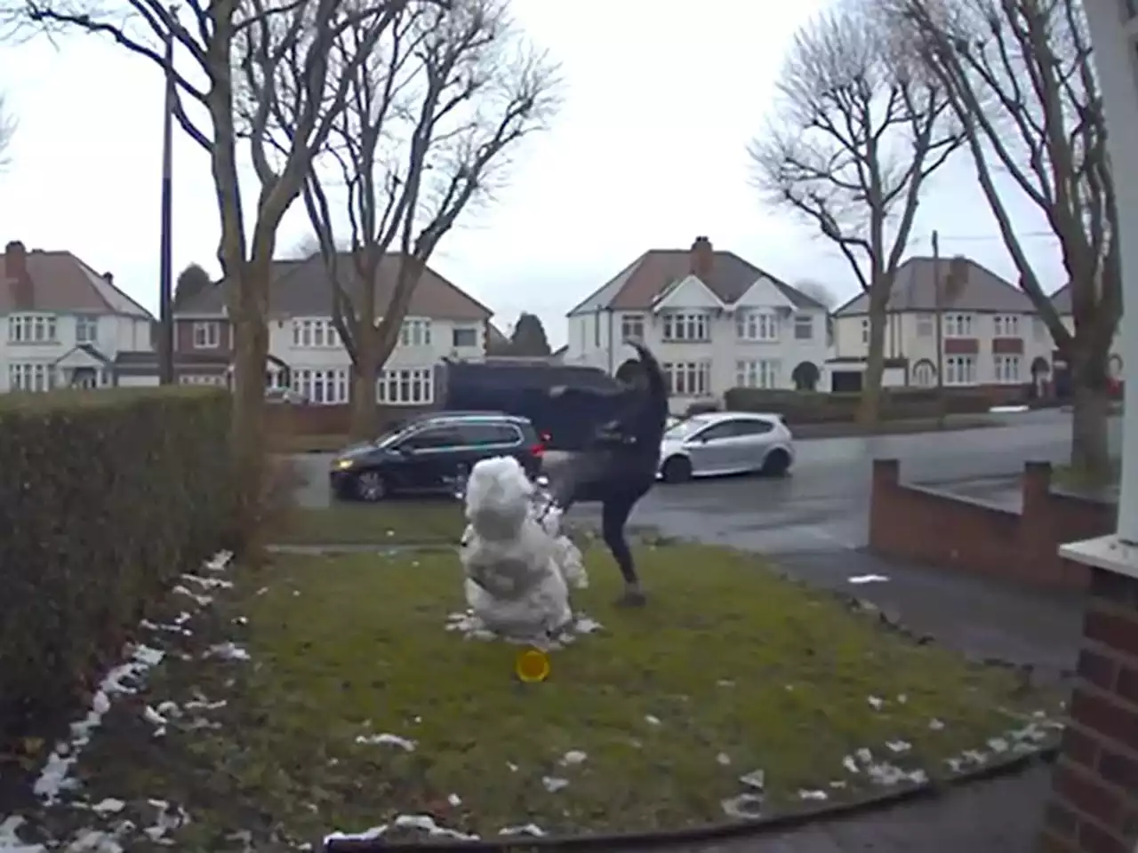 Doorbell camera catches man from passing car kicking nine-year-old girl's snowman into pieces