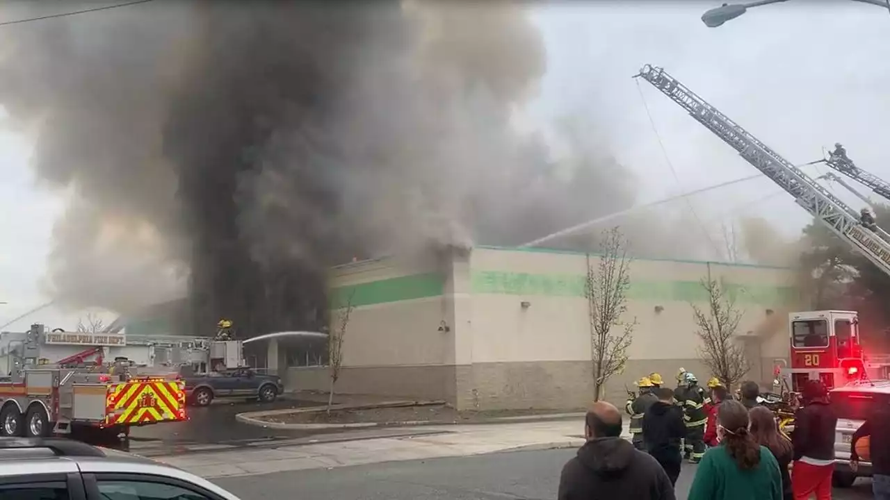 Firefighters battle 2-alarm blaze at a business in Wissinoming