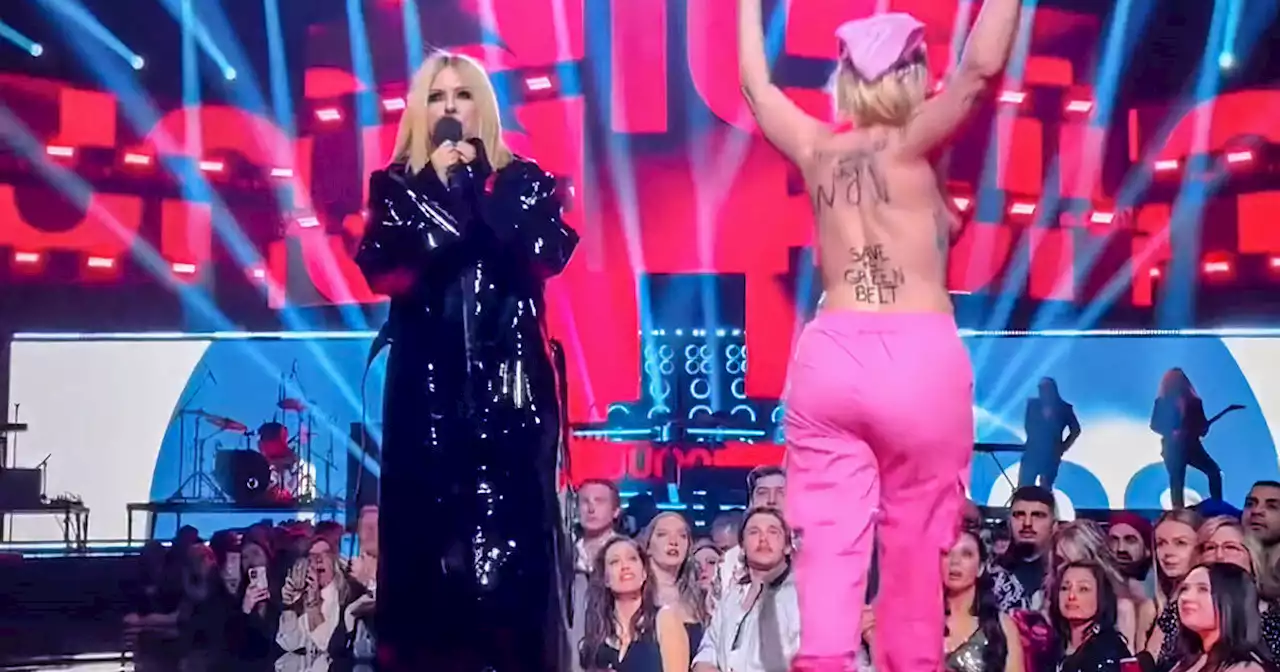 Topless protester rushes stage at Juno Awards and gets told off by Avril Lavigne