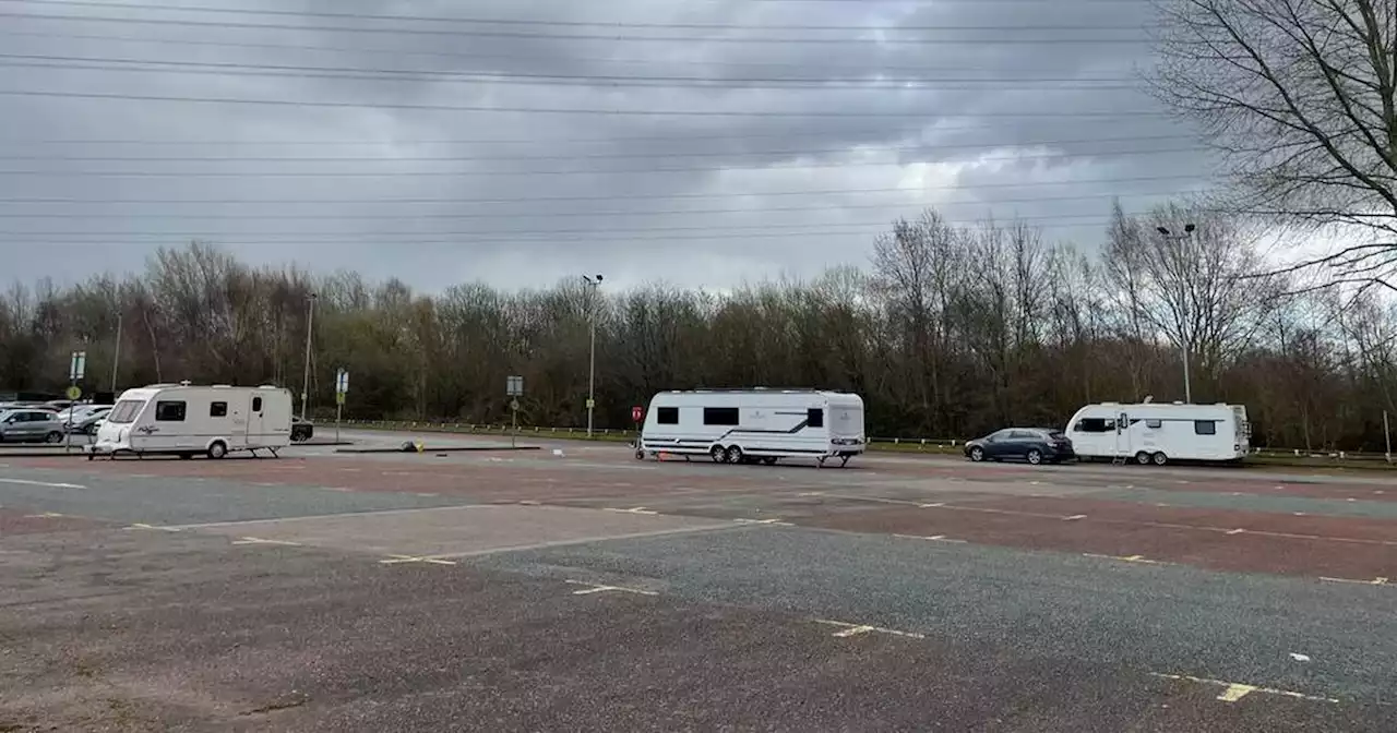 Travellers set up at busy city park and ride site